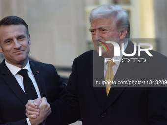 France's President Emmanuel Macron welcomes the United States President-elect Donald Trump before the bilateral talks in Paris, France, on D...