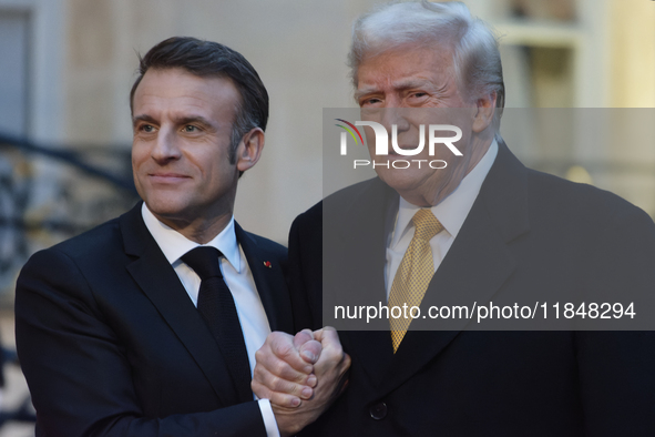 France's President Emmanuel Macron welcomes the United States President-elect Donald Trump before the bilateral talks in Paris, France, on D...