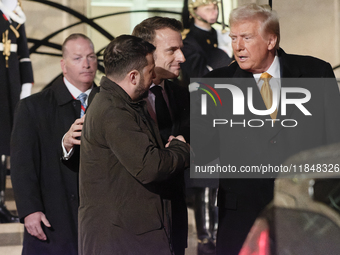 The United States President-elect Donald Trump and the Ukrainian President Volodymyr Zelensky shake hands in front of France's President Emm...