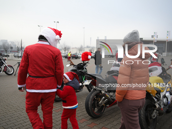 Motorcyclists in Santa Claus costumes get ready for the parade at EXPO Krakow in Krakow, Poland, on December 8, 2024. Santas on motorbikes r...