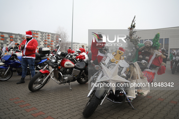 Motorcyclists in Santa Claus costumes get ready for the parade at EXPO Krakow in Krakow, Poland, on December 8, 2024. Santas on motorbikes r...