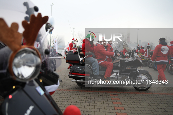 Motorcyclists in Santa Claus costumes get ready for the parade at EXPO Krakow in Krakow, Poland, on December 8, 2024. Santas on motorbikes r...