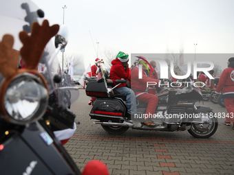 Motorcyclists in Santa Claus costumes get ready for the parade at EXPO Krakow in Krakow, Poland, on December 8, 2024. Santas on motorbikes r...