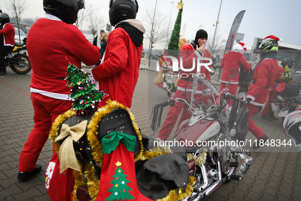 Motorcyclists in Santa Claus costumes get ready for the parade at EXPO Krakow in Krakow, Poland, on December 8, 2024. Santas on motorbikes r...