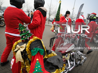 Motorcyclists in Santa Claus costumes get ready for the parade at EXPO Krakow in Krakow, Poland, on December 8, 2024. Santas on motorbikes r...