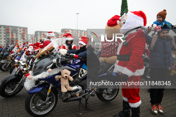 Motorcyclists in Santa Claus costumes get ready for the parade at EXPO Krakow in Krakow, Poland, on December 8, 2024. Santas on motorbikes r...