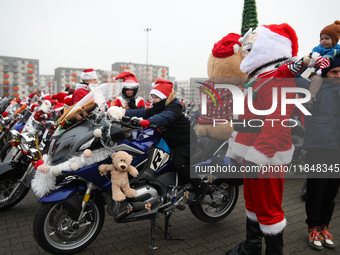 Motorcyclists in Santa Claus costumes get ready for the parade at EXPO Krakow in Krakow, Poland, on December 8, 2024. Santas on motorbikes r...