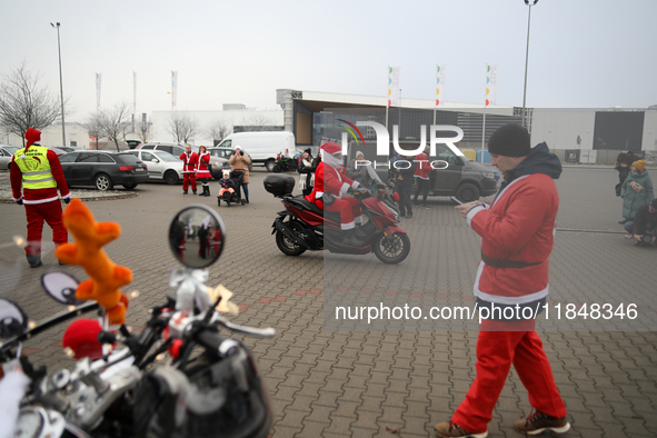 Motorcyclists in Santa Claus costumes get ready for the parade at EXPO Krakow in Krakow, Poland, on December 8, 2024. Santas on motorbikes r...