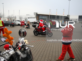 Motorcyclists in Santa Claus costumes get ready for the parade at EXPO Krakow in Krakow, Poland, on December 8, 2024. Santas on motorbikes r...