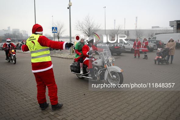 Motorcyclists in Santa Claus costumes get ready for the parade at EXPO Krakow in Krakow, Poland, on December 8, 2024. Santas on motorbikes r...