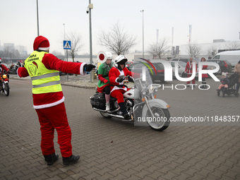 Motorcyclists in Santa Claus costumes get ready for the parade at EXPO Krakow in Krakow, Poland, on December 8, 2024. Santas on motorbikes r...