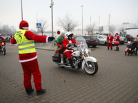 Motorcyclists in Santa Claus costumes get ready for the parade at EXPO Krakow in Krakow, Poland, on December 8, 2024. Santas on motorbikes r...