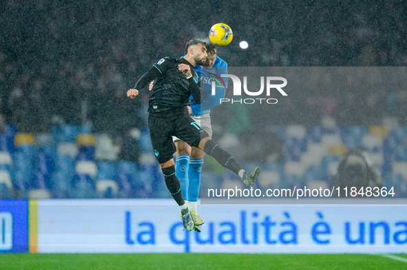 Taty Castellanos of SS Lazio and Amir Rrahmani of SSC Napoli jump for the ball during the serie Serie A Enilive match between SSC Napoli and...