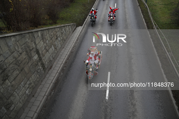 In Krakow, Poland, on December 8, 2024, motorcyclists in Santa costumes ride through the streets of the city to the University Children's Ho...