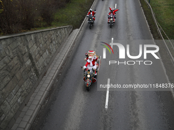 In Krakow, Poland, on December 8, 2024, motorcyclists in Santa costumes ride through the streets of the city to the University Children's Ho...