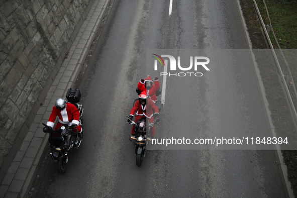 In Krakow, Poland, on December 8, 2024, motorcyclists in Santa costumes ride through the streets of the city to the University Children's Ho...