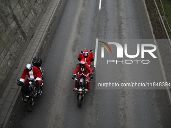 In Krakow, Poland, on December 8, 2024, motorcyclists in Santa costumes ride through the streets of the city to the University Children's Ho...