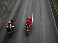 In Krakow, Poland, on December 8, 2024, motorcyclists in Santa costumes ride through the streets of the city to the University Children's Ho...