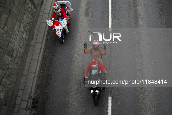 In Krakow, Poland, on December 8, 2024, motorcyclists in Santa costumes ride through the streets of the city to the University Children's Ho...