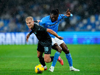 Andre-Frank Zambo Anguissa of SSC Napoli and Gustav Isaksen of SS Lazio compete for the ball during the serie Serie A Enilive match between...