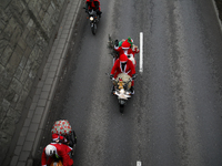 In Krakow, Poland, on December 8, 2024, motorcyclists in Santa costumes ride through the streets of the city to the University Children's Ho...