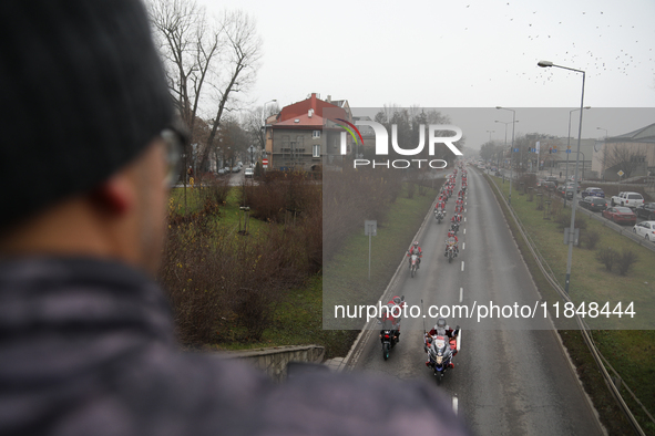 In Krakow, Poland, on December 8, 2024, motorcyclists in Santa costumes ride through the streets of the city to the University Children's Ho...