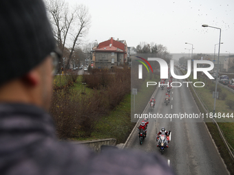 In Krakow, Poland, on December 8, 2024, motorcyclists in Santa costumes ride through the streets of the city to the University Children's Ho...