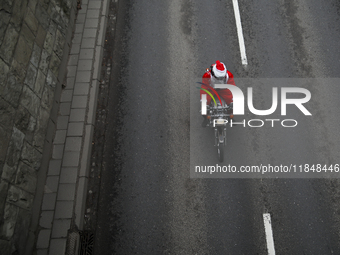 In Krakow, Poland, on December 8, 2024, motorcyclists in Santa costumes ride through the streets of the city to the University Children's Ho...