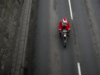 In Krakow, Poland, on December 8, 2024, motorcyclists in Santa costumes ride through the streets of the city to the University Children's Ho...