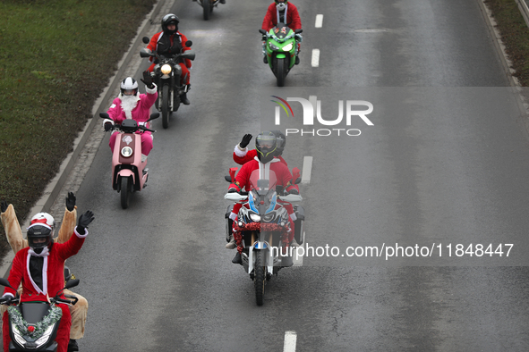 In Krakow, Poland, on December 8, 2024, motorcyclists in Santa costumes ride through the streets of the city to the University Children's Ho...