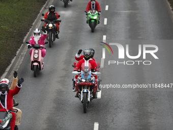 In Krakow, Poland, on December 8, 2024, motorcyclists in Santa costumes ride through the streets of the city to the University Children's Ho...