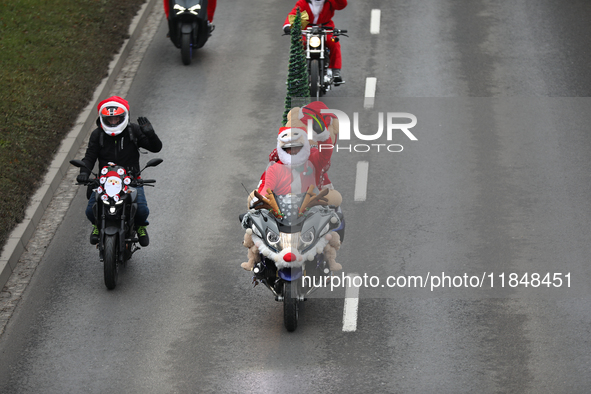 In Krakow, Poland, on December 8, 2024, motorcyclists in Santa costumes ride through the streets of the city to the University Children's Ho...