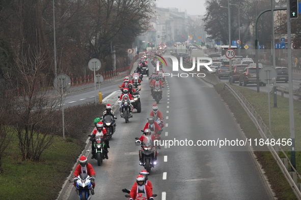 In Krakow, Poland, on December 8, 2024, motorcyclists in Santa costumes ride through the streets of the city to the University Children's Ho...