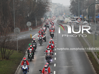 In Krakow, Poland, on December 8, 2024, motorcyclists in Santa costumes ride through the streets of the city to the University Children's Ho...