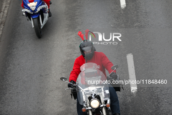 In Krakow, Poland, on December 8, 2024, motorcyclists in Santa costumes ride through the streets of the city to the University Children's Ho...