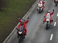 In Krakow, Poland, on December 8, 2024, motorcyclists in Santa costumes ride through the streets of the city to the University Children's Ho...