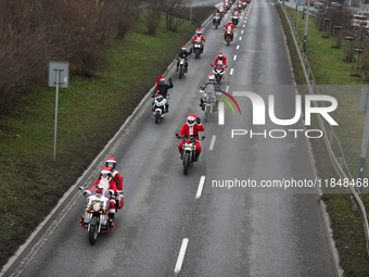 In Krakow, Poland, on December 8, 2024, motorcyclists in Santa costumes ride through the streets of the city to the University Children's Ho...