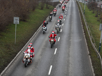 In Krakow, Poland, on December 8, 2024, motorcyclists in Santa costumes ride through the streets of the city to the University Children's Ho...