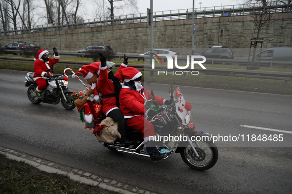 In Krakow, Poland, on December 8, 2024, motorcyclists in Santa costumes ride through the streets of the city to the University Children's Ho...