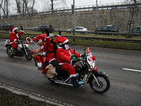 In Krakow, Poland, on December 8, 2024, motorcyclists in Santa costumes ride through the streets of the city to the University Children's Ho...