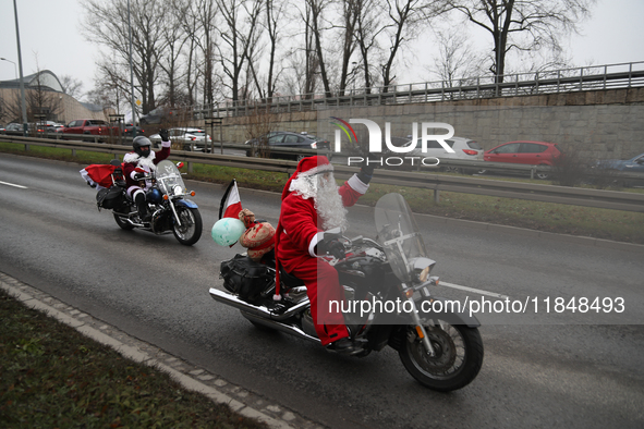 In Krakow, Poland, on December 8, 2024, motorcyclists in Santa costumes ride through the streets of the city to the University Children's Ho...