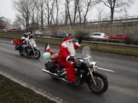 In Krakow, Poland, on December 8, 2024, motorcyclists in Santa costumes ride through the streets of the city to the University Children's Ho...