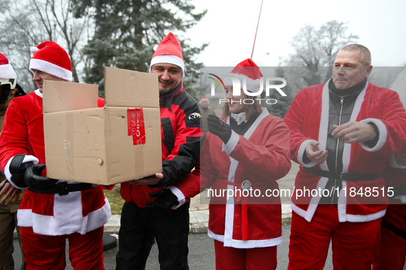 In Krakow, Poland, on December 8, 2024, motorcyclists in Santa costumes hand out gifts at the University Children's Hospital. Santas on moto...