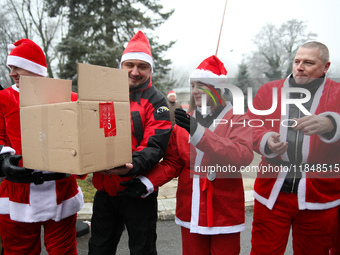 In Krakow, Poland, on December 8, 2024, motorcyclists in Santa costumes hand out gifts at the University Children's Hospital. Santas on moto...