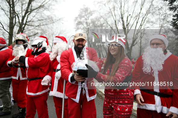 In Krakow, Poland, on December 8, 2024, motorcyclists in Santa costumes hand out gifts at the University Children's Hospital. Santas on moto...