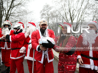 In Krakow, Poland, on December 8, 2024, motorcyclists in Santa costumes hand out gifts at the University Children's Hospital. Santas on moto...