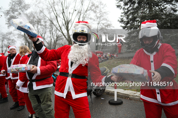 In Krakow, Poland, on December 8, 2024, motorcyclists in Santa costumes hand out gifts at the University Children's Hospital. Santas on moto...