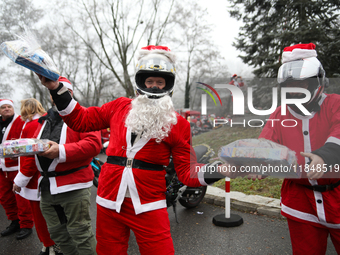 In Krakow, Poland, on December 8, 2024, motorcyclists in Santa costumes hand out gifts at the University Children's Hospital. Santas on moto...