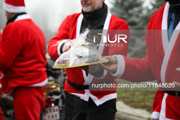 In Krakow, Poland, on December 8, 2024, motorcyclists in Santa costumes hand out gifts at the University Children's Hospital. Santas on moto...