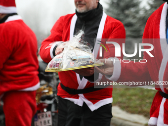 In Krakow, Poland, on December 8, 2024, motorcyclists in Santa costumes hand out gifts at the University Children's Hospital. Santas on moto...